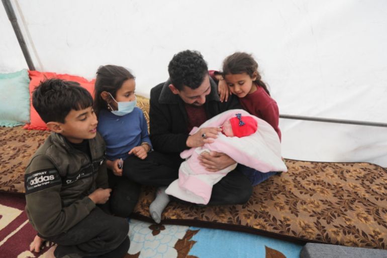 AFRIN, SYRIA - FEBRUARY 19: An infant pulled alive from earthquake-shattered home in Jinderis town arrives new home after being discharged from a hospital in Afrin district of Aleppo, northern Syria on February 19, 2023. Rescuers discovered the baby whose mother gave birth to her under rubble. Baby Afra, the sole survivor of her immediate family, adopted by her aunt, the only living relative, and the new family temporarily moved into a tent after their home also collapsed in earthquake, centered in Kahramanmaras province of Turkiye. (Photo by Bekir Kasim/Anadolu Agency via Getty Images)