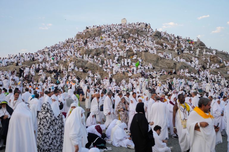 Muslim pilgrims gather at the top of the rocky hill known as the Mountain of Mercy, on the Plain of Arafat, during the annual Hajj pilgrimage, near the holy city of Mecca, Saudi Arabia, Saturday, June 15, 2024. (AP Photo/Rafiq Maqbool)