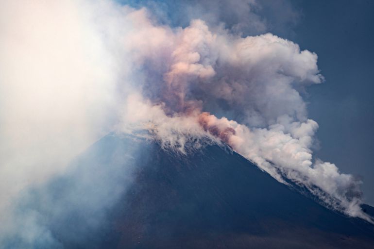 Smoke billows from Mount Etna volcano, Italy, Monday, June 2, 2025. (AP Photo/Giuseppe Distefano)