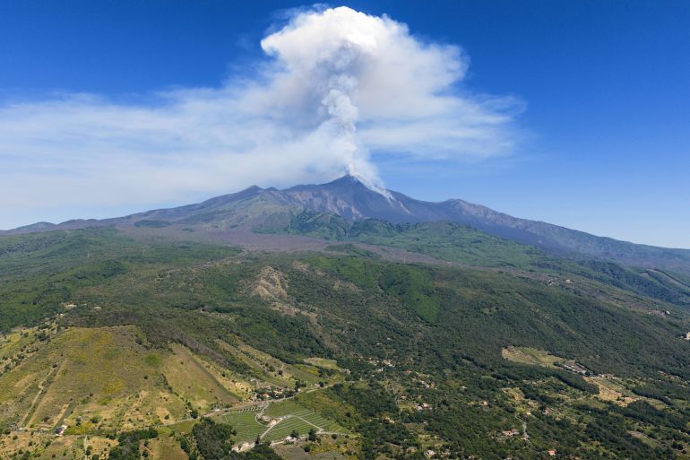 Smoke billows from Mount Etna volcano, Italy, Monday, June 2, 2025. (AP Photo/Giuseppe Distefano)