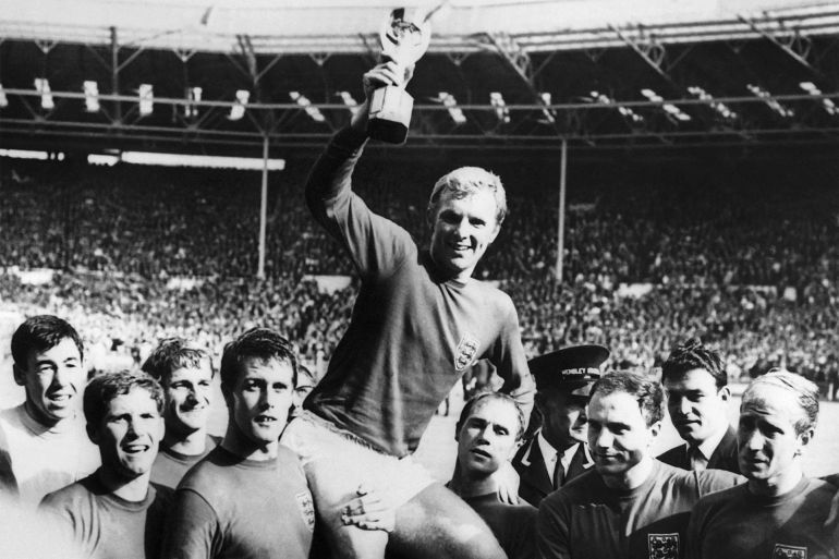 England's national soccer team captain Bobby Moore holds aloft the Jules Rimet trophy as he is carried by his teammates following England's victory over Germany (4-2 in extra time) in the World Cup final 30 July 1966 at Wembley stadium in London.(From L : Gordon Banks, Alan Ball, Roger Hunt, Geoff Hurst - who scored three goals - , Ray Wilson, George Cohen and Bobby Charlton) (Photo by CENTRAL PRESS / AFP)