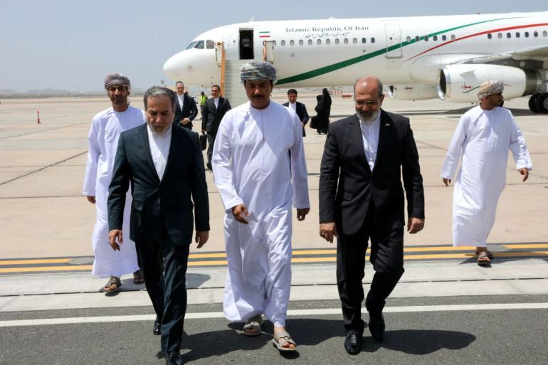 Iran's Foreign Minister Abbas Araghchi is welcomed by an unidentified Omani official upon his arrival in Muscat, Oman, May 11, 2025. Iranian Foreign Ministry/WANA (West Asia News Agency)/Handout via REUTERS ATTENTION EDITORS - THIS PICTURE WAS PROVIDED BY A THIRD PARTY