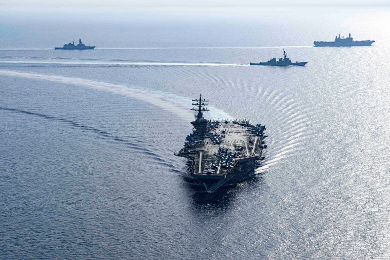 This handout photo released by the US Defence Visual Information Distribution Service (DVIDS) shows the US Navy Nimitz-class aircraft carrier USS Dwight D. Eisenhower (CVN 69) and Arleigh Burke-class guided-missile destroyers USS Laboon (DDG 58) and USS Gravely (DDG 107), part of the Dwight D. Eisenhower Carrier Group (IKECSG), sailing in formation in the Red Sea with the Italian aircraft carrier ITS Cavour (CVH 550) on June 7, 2024, as part of their mission to support maritime stability and security in the Middle East region. (Photo by DVIDS / AFP) / RESTRICTED TO EDITORIAL USE - MANDATORY CREDIT 