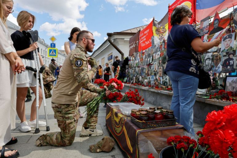 FILE PHOTO: People gather in front of a makeshift memorial, which was erected following head of Russia's Wagner mercenary group Yevgeny Prigozhin and group commander Dmitry Utkin's death in 2023, during a commemoration ceremony held to pay tribute to Wagner fighters, who were recently killed in Mali by northern Tuareg rebels, in central Moscow, Russia August 4, 2024. REUTERS/Yulia Morozova/File Photo
