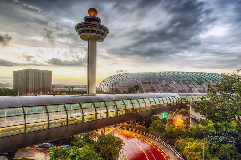 Singapore, Changi Airport, Terminal 2, passenger transit tunnel and control tower at dusk