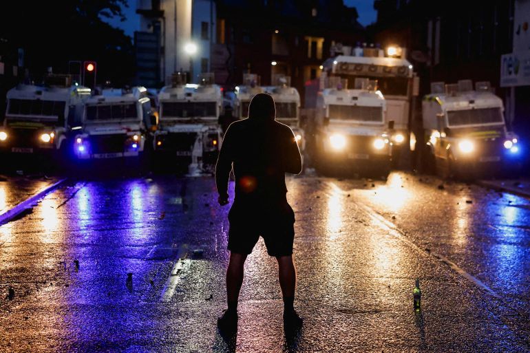 A demonstrator faces a group of riot police vehicles as riots continue in Ballymena, Northern Ireland, June 11, 2025. REUTERS/Clodagh Kilcoyne TPX IMAGES OF THE DAY (Reuters)