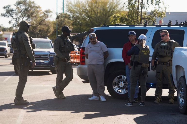 U.S. Immigrations and Customs (ICE) Homeland Security Investigations (HSI) agents detain two documented immigrants with prior convictions at a Home Depot parking lot in Tucson, Arizona, U.S., January 26, 2025. REUTERS/Rebecca Noble
