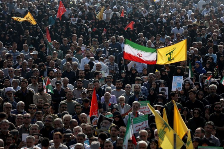 People attend the funeral ceremony of Iranian Revolutionary Guards' (IRGC) deputy commander Brigadier General Abbas Nilforoushan who was killed in the Israeli strikes on Beirut, in Tehran, Iran, October 15, 2024. Majid Asgaripour/WANA (West Asia News Agency) via REUTERS ATTENTION EDITORS - THIS IMAGE HAS BEEN SUPPLIED BY A THIRD PARTY.