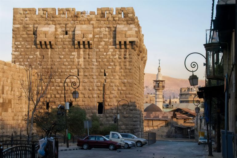 Sunrise over Damascus, Syria with one of the fortified walls of the Old City. This image was taken on a winter morning.