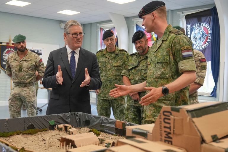 British Prime Minister Keir Starmer looks at a mock-up of a military encampment as he visits the Netherlands marines training base, as part of the UK-Netherland Joint Amphibious Force in Rotterdam, Netherlands, Tuesday, June 24, 2025, on the sidelines of the NATO summit, which is being held in The Hague. (AP Photo/Kin Cheung, Pool)