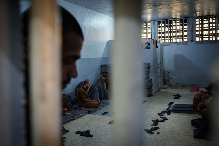 Inmates accused of being an Islamic State (ISIS) fighters sit inside a cell at the Syrian Democratic Forces-run Gweiran Prison, now called Panorama, in Hassakeh, northeastern Syria, Friday, Jan. 31, 2025. (AP Photo/Bernat Armangue)