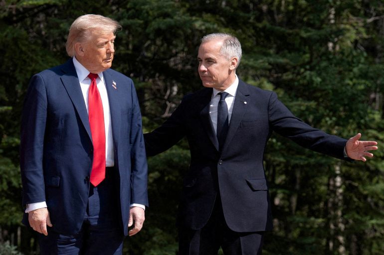 FILE PHOTO: U.S. President Donald Trump is greeted by Prime Minister of Canada Mark Carney, as he arrives at the G7 leaders' summit in Kananaskis, Alberta, Canada June 16, 2025. Stefan Rousseau/Pool via REUTERS/File Photo