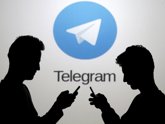Two men pose with smartphones in front of a screen showing the Telegram logo in this picture illustration taken in Zenica, Bosnia and Herzegovina November 18, 2015. The mobile messaging service Telegram, created by the exiled founder of Russia's most popular social network site, has emerged as an important new promotional and recruitment platform for Islamic State. The service, set up two years ago, has caught on in many corners of the globe as an ultra-secure way to quickly upload and share videos, texts and voice messages. It counts 60 million active users around the world. Picture taken November 18. REUTERS/Dado Ruvic