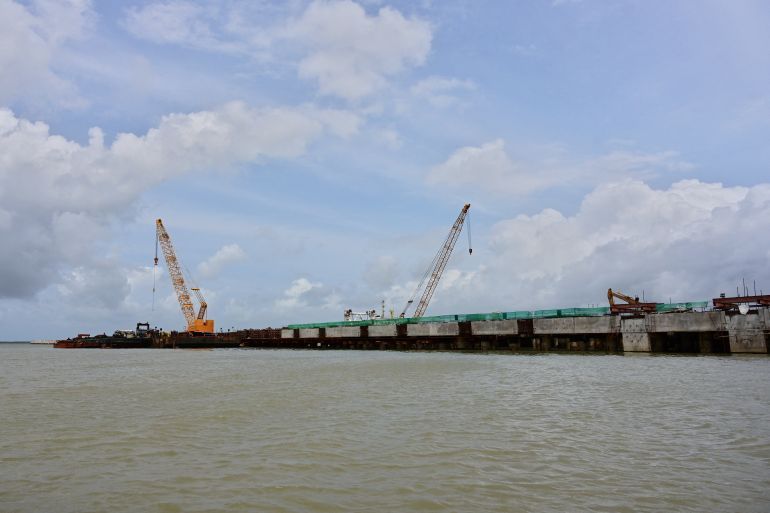 This picture taken on June 17, 2019 shows the ongoing construction of a port near the resort town of Lamu, a UNESCO world heritage site that is the oldest Swahili settlement in Africa. The ambitious project is called Lamu Port, South Sudan, Ethiopia Transport Corridor (LAPSSET), and construction is well underway, with one of the first berths of the port nearly completed. The inhabitants fear about the environmental impact of the project with dredging covering a key coral reef with silt and devastating a popular fishing spot. (Photo by TONY KARUMBA / AFP)