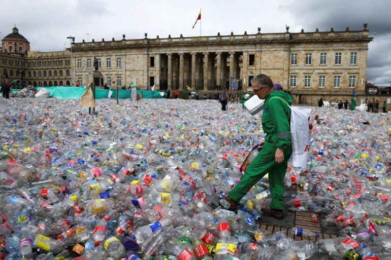 A recycler walks through recyclable material dumped in Plaza de Bolivar, as people protest against the drop in recycled material prices, in Bogota, Colombia, June 24, 2025. REUTERS/Luisa Gonzalez