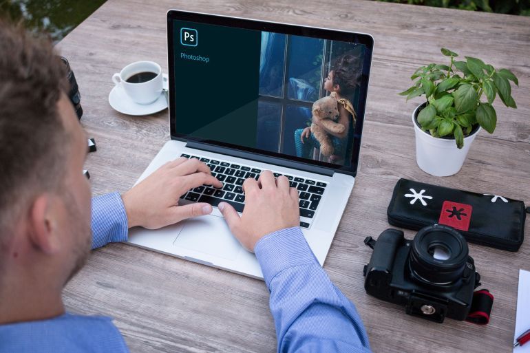 Shillong,Meghalaya,India 5th September 2020 , A person seeing Adobe photoshop loading screen on laptop screen close-up.; Shutterstock ID 1809376864; purchase_order: aljazeera ; job: ; client: ; other: