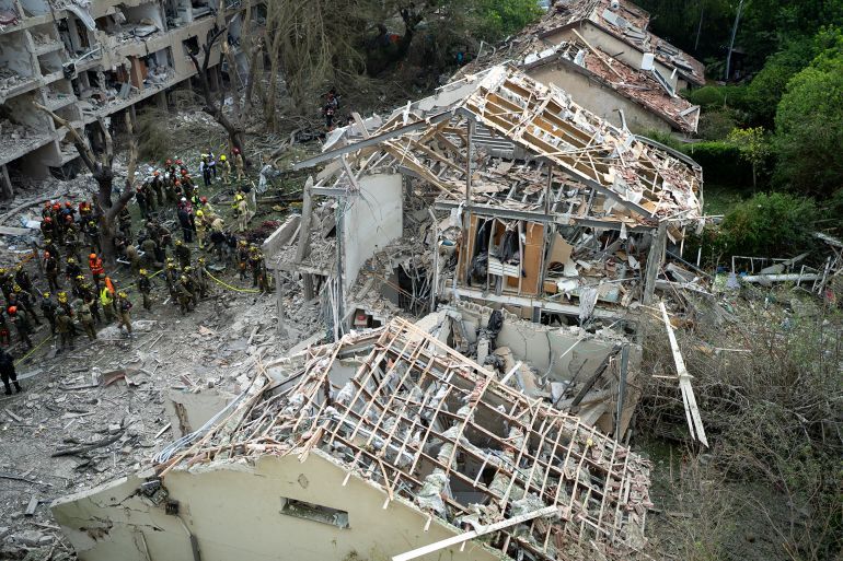 TEL AVIV, ISRAEL - JUNE 22: Emergency workers respond to the site of a missile strike in the Ramat Aviv neighborhood of Tel Aviv on June 22, 2025 in Tel Aviv, Israel. Israel was hit with a fresh wave of aerial attacks by Iran after the US entered the war overnight and bombed several Iranian nuclear sites. (Photo by Erik Marmor/Getty Images)