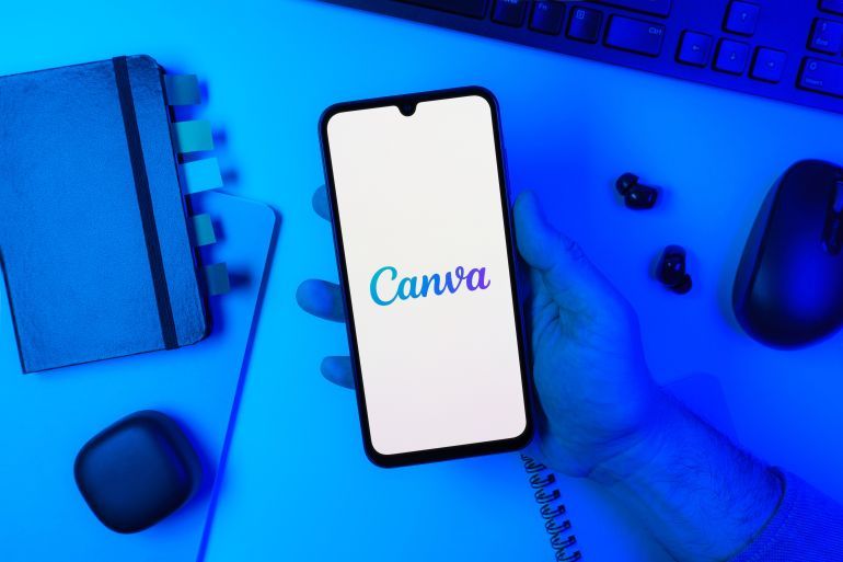 Prague, Czechia - 10 21 2024: Smartphone on surface showing Canva logo.