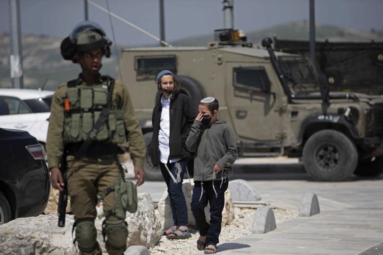 Israelis settlers visit nearby archaeological sites which include which include a Roman basilica and forum and the Nabi Yahya Mosque, a former Crusader cathedral, after a demonstration to mark Land Day and to protest Israelis settlers visiting the archaeological sites, in the village of Sebastia, near the West Bank city of Nablus, Tuesday, March 30, 2021. (AP Photo/Majdi Mohammed)