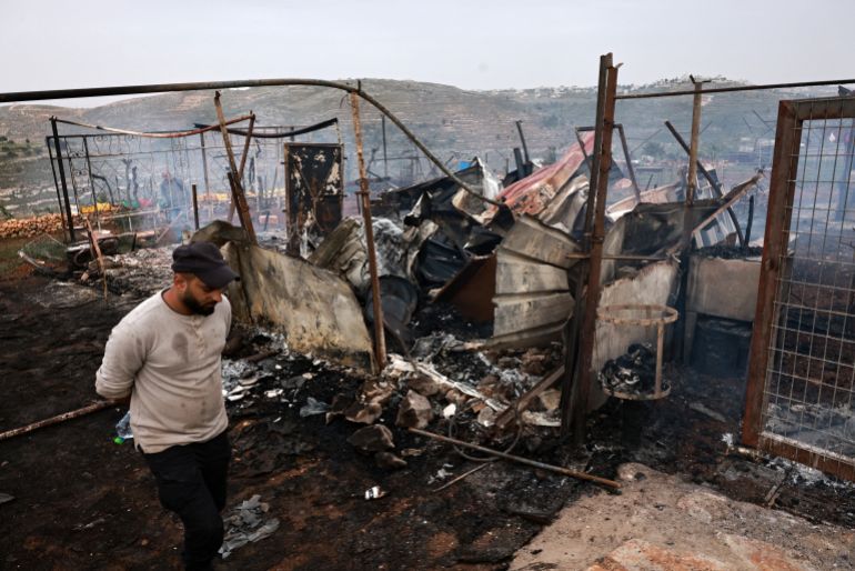 A man checks the damage in an agricultural installation, following an attack by Israeli settlers in the village of Sinjil, north of the occupied West Bank city of Ramallah on April 23, 2025. (Photo by Zain JAAFAR / AFP)