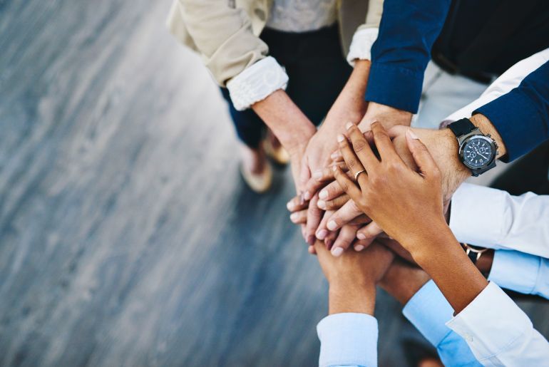 Group, business people and hands in stack for teamwork, collaboration or diversity in workplace community. Crowd, above or solidarity at company office for staff commitment, together for support