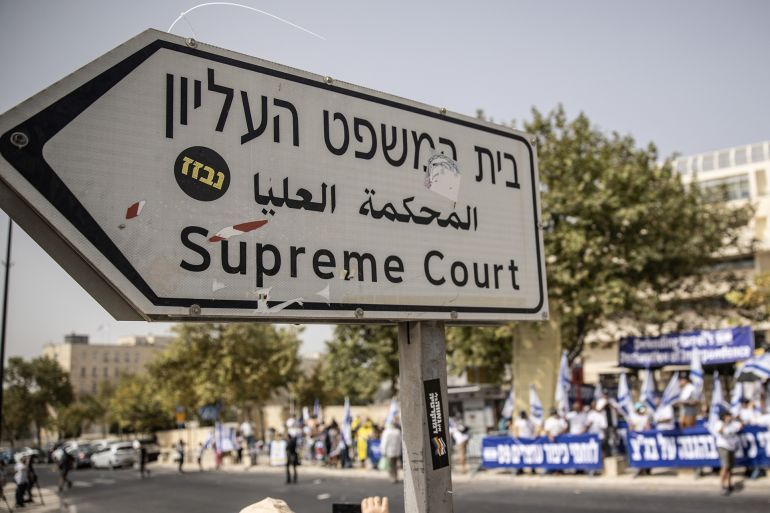 JERUSALEM - SEPTEMBER 12: People gather outside Supreme Court during a demonstration against Israeli Prime Minister Benjamin Netanyahu and government's judicial reform ahead of an appeal against an amendment that curbs some powers of the Supreme Court, in Jerusalem, September 12, 2023. Talks resumed between the Israeli government and opposition for reaching a compromise on controversial judicial overhaul, according to local media on Monday. (Photo by Mostafa Alkharouf/Anadolu Agency via Getty Images)