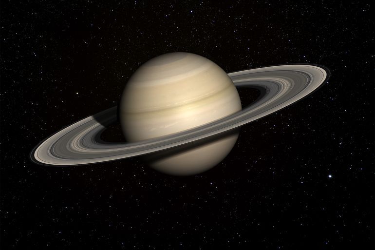 زحل يتقدم ليعتلي صدارة أكثر الكواكب امتلاكا للأقمار بإجمالي 145 قمرا. (غيتي) Saturn with stars in the background. - stock photo A 3D render made with 