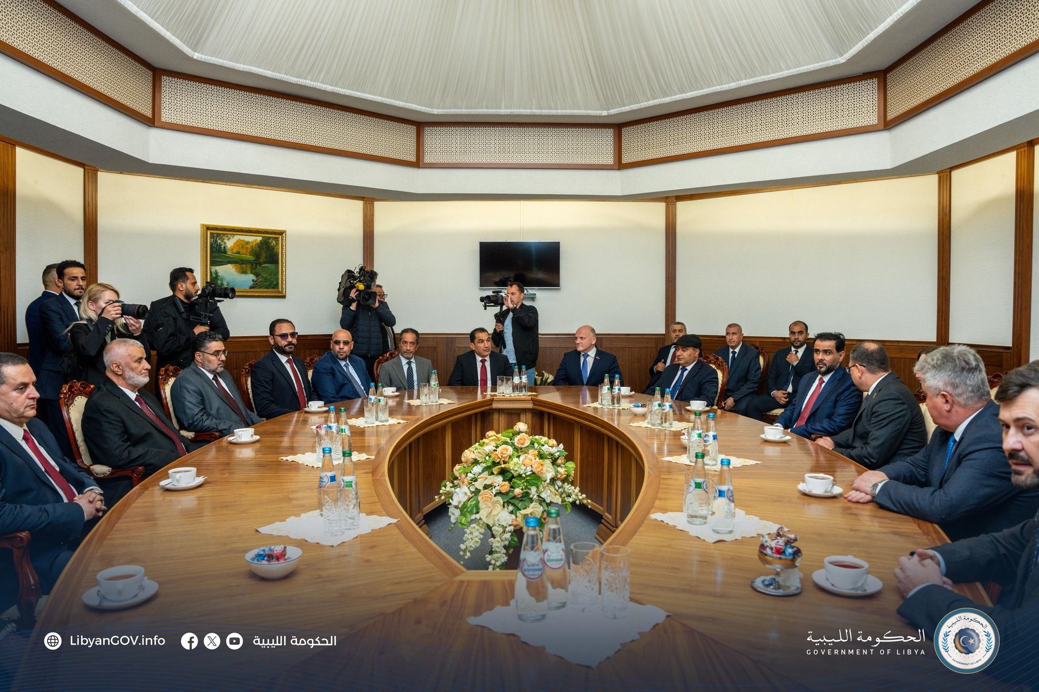 May be an image of ‎14 people, dais and ‎text that says '‎LibyanCOV.info الحكومة الليبية الحكومة OF الحكومةالليبية لليبية OVERNMENTOFLIBYA‎'‎‎