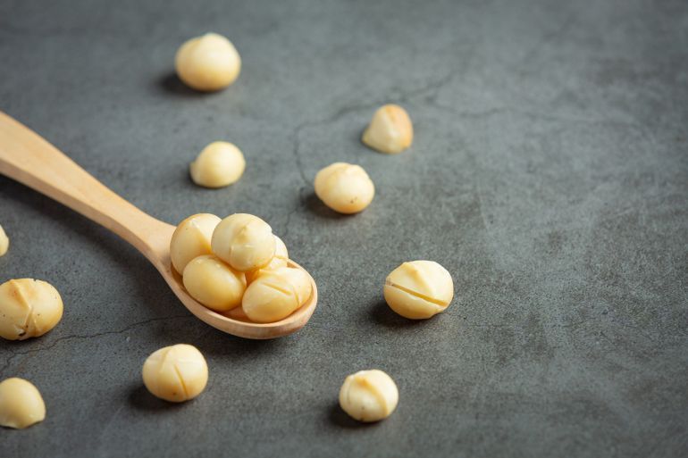 Heap of macadamia raw seed فري بيك