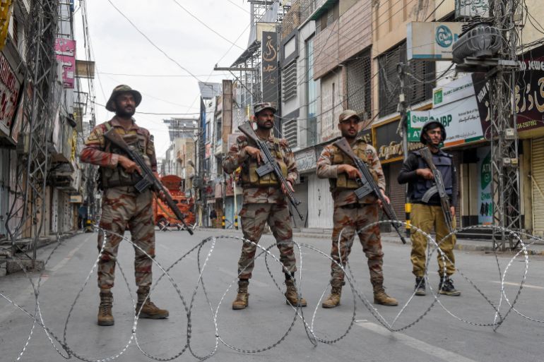 Pakistani soldiers stand guard during a Shiite Muslim religious procession in Quetta on July 3, 2025, during the Islamic holy month of Muharram in the lead-up to Ashura, a 10-day period commemorating the seventh-century killing of Prophet Mohammed's grandson, Imam Hussein.