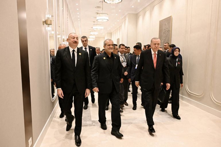 This handout photograph released by the Azerbaijani presidential press service on July 4, 2025, shows attendees, including Turkish President Recep Tayyip Erdogan, Azerbaijani President Ilham Aliyev and Iranian President Masoud Pezeshkian, taking part in the 17th Summit of the Economic Cooperation Organization in Khankendi, Azerbaijan. (Photo by Handout / Azerbaijani presidency / AFP) / RESTRICTED TO EDITORIAL USE - MANDATORY CREDIT