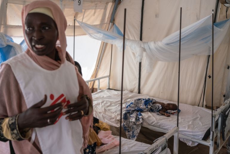 ADRE, CHAD - SEPTEMBER 19: Huda Abdulha, a health promotion worker, talks with patients in the Doctors Without Borders clinic inside the Adre camp, where around 200,000 people are currently taking refuge on September 19, 2023 in Adre, Chad. The conflict in Sudan, entering its sixth month, has left thousands of civilians dead and displaced more than five million people. More than 420,000 people have already found refuge in neighbouring Chad as hundreds continue to arrive daily. (Photo by Abdulmonam Eassa/Getty Images)