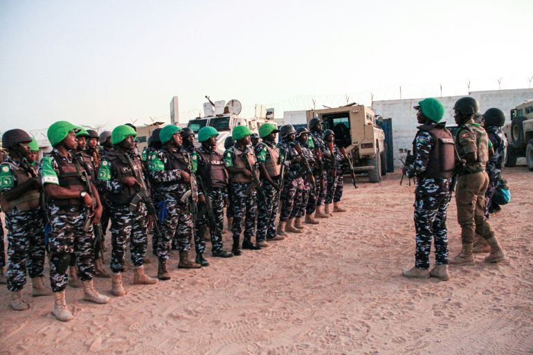 Police officers of the African Union's peacekeeping mission in Somalia (AMISOM) from Uganda, Kenya, Sierra Leone, Nigeria, Ghana and Zambia gather before their night patrol deployment at the base in Mogadishu on September 17, 2019. (Photo by Tina SMOLE / AFP)