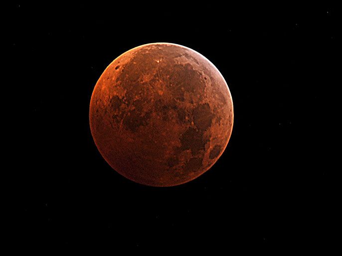 (FILES)This file photo taken in Manassas, Virginia shows the moon during the peak of a total eclipse on December, 21, 2010. Two spacecraft orbiting the moon are ending their mission by crashing into a lunar mountain at almost 4,000mph (6,437kph). The twin Gravity Recovery and Interior Laboratory (Grail) probes, known as Ebb and Flow, have spent almost a year mapping the moon's gravity in unprecedented detail. With their fuel running low, US space agency Nasa took the decision to stage a 
