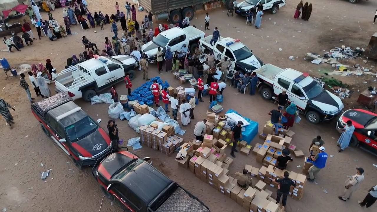 May be an image of 1 person, jeep, car and crowd