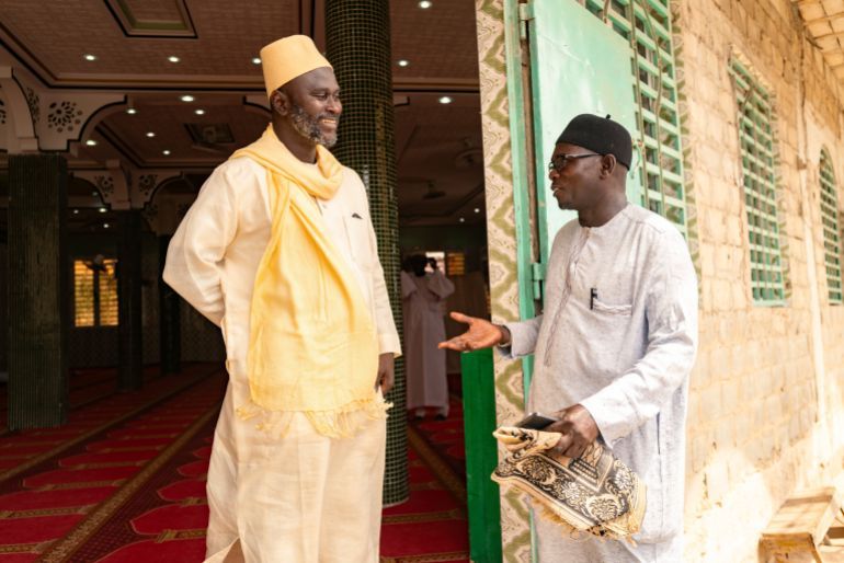 Imam Ibrahima Diane, left, advocate for an end to gender-based violence and practices like female genital mutilation, discusses with El Hadj Malick, coordinator of the