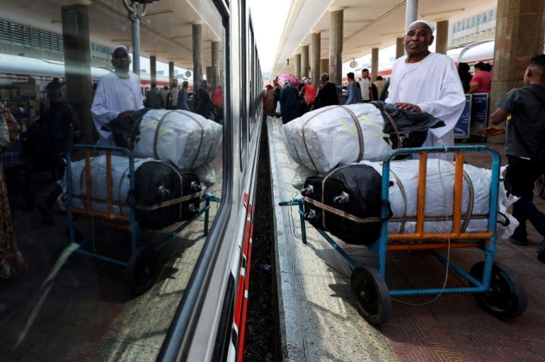 FILE PHOTO: A Sudanese man waits next to his luggage, as families displaced by conflict between the Sudanese Armed Forces and the Rapid Support Forces (RSF) crowd at Cairo’s main station to board a free train with a voluntary return coordinated by the Egyptian government to Aswan, where buses will take them back to their homes in Khartoum, in Cairo, Egypt July 28, 2025. REUTERS/Amr Abdallah Dalsh/File Photo