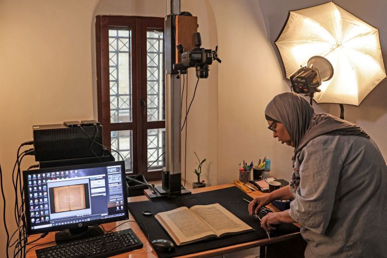 Shaimaa al-Budeiri, a digital archive officer at the Khalidi library, speaks during an interview at her office in the library in the old city of Jerusalem on June 20.2023. Located in the walled Old City near an entrance to the Al Aqsa mosque complex, the library was founded by Palestinian notable Raghib Al-Khalidi in 1900 at the request of his late mother Khadija. It also holds Persian, German and French books, including an impressive collection of 60 titles by Victor Hugo. Its founder studied at the Sorbonne in Paris. (Photo by AHMAD GHARABLI / AFP)