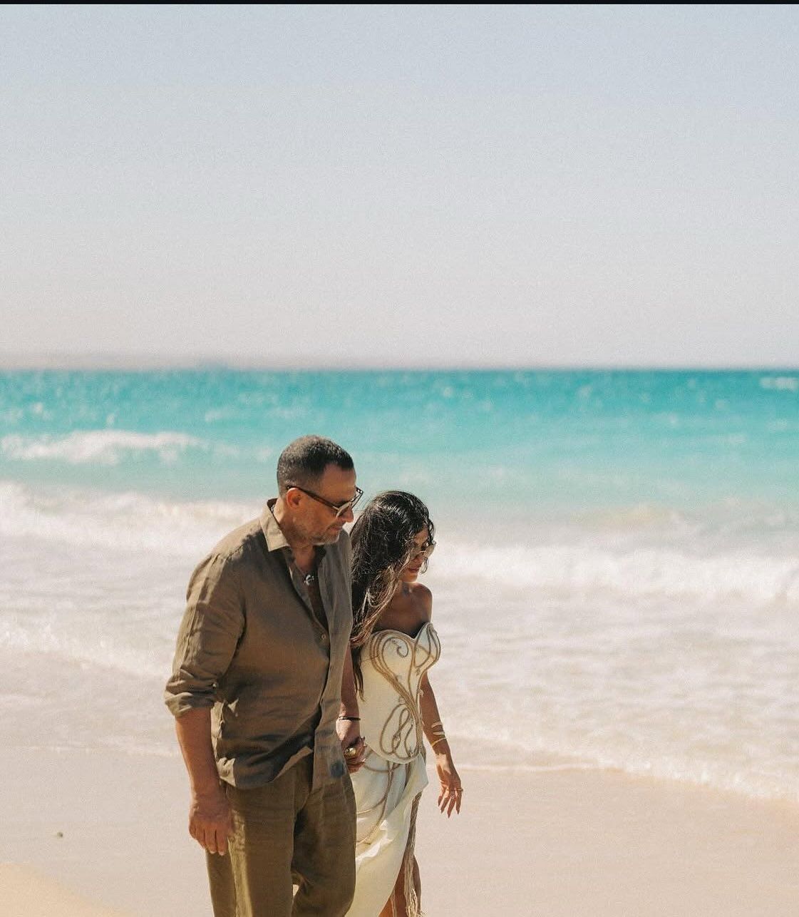 May be an image of 2 people, wedding, beach and ocean