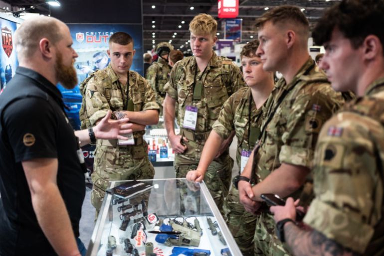 LONDON, ENGLAND - SEPTEMBER 15: Members of the armed forces speak with a member of a laser sight company sales team on day two of the DSEI (Defence and Security Equipment International) exhibition at ExCel on September 15, 2021 in London, England. The four day event sees over 1,000 defence, technology and security manufacturers display their latest developments to Governments and security companies from around the world. (Photo by Leon Neal/Getty Images) (Photo by Leon Neal/Getty Images)
