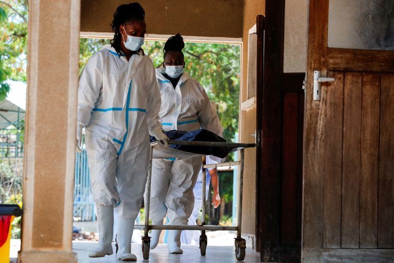 Workers wheel the remains of a follower of a Christian cult named Good News International Church, who believed they would go to heaven if they starved themselves to death in Shakahola, who was exhumed last year as the authorities began to hand over bodies to family members, at the Malindi sub-district hospital mortuary in Malindi, Kilifi county, Kenya March 26, 2024. REUTERS/Thomas Mukoya