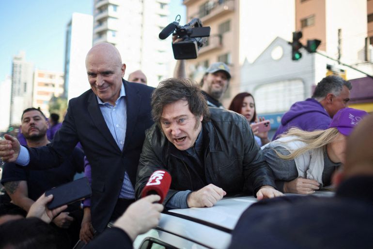 Argentina's President Javier Milei speaks to the media, while standing on a vehicle with lawmaker Jose Luis Espert to attend a La Libertad Avanza party rally ahead of legislative elections in the province of Buenos Aires, in Lomas de Zamora on the outskirts of Buenos Aires, Argentina, August 27, 2025. REUTERS/Agustin Marcarian