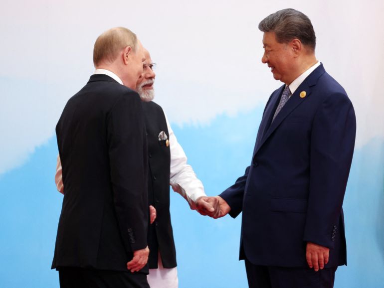 In this pool photograph distributed by the Russian state agency Sputnik, Russia's President Vladimir Putin (front L) speaks with India's Prime Minister Narendra Modi (C) and China's President Xi Jinping during the Shanghai Cooperation Organisation (SCO) Summit in Tianjin on September 1, 2025.