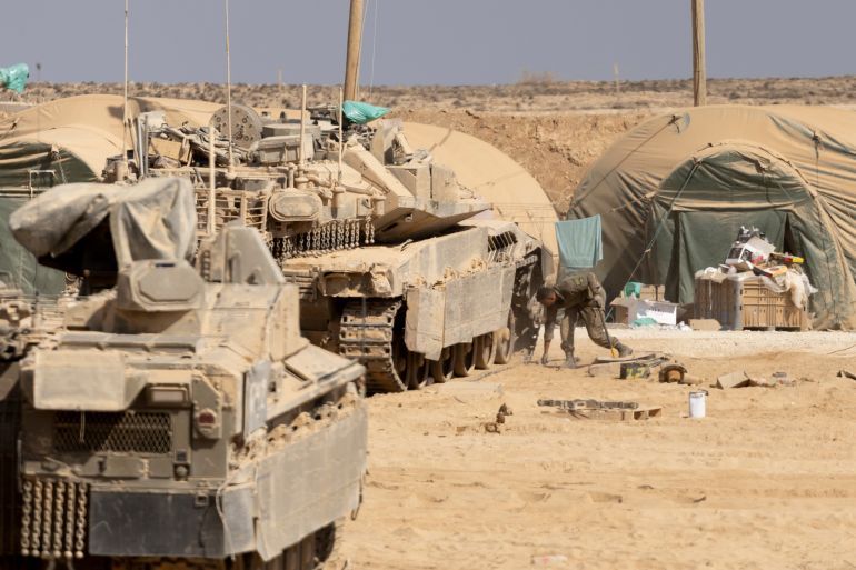 SOUTHERN ISRAEL, ISRAEL - AUGUST 31: An Israeli soldier works on a tank near the border with the Gaza Strip as seen from a position on the Israeli side of the border on August 31, 2025 in Southern Israel, Israel. An Israel Defence Forces (IDF) spokesman has called the evacuation of one million people in Gaza City