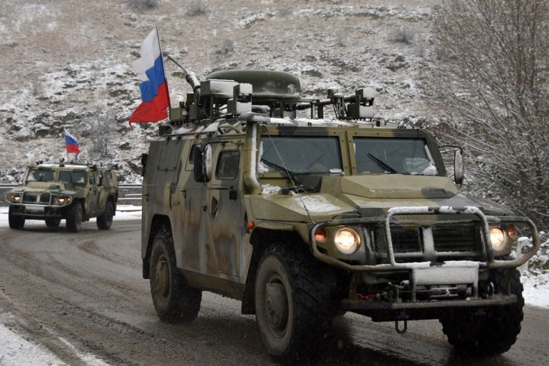 Military vehicles of the Russian peacekeeping force move on the road outside Lachin on November 29, 2020, after six weeks of fighting between Armenia and Azerbaijan over the disputed Nagorno-Karabakh region. - A Moscow-brokered peace deal was announced on November 10 after Azerbaijan's military overwhelmed Armenian separatist forces and threatened to advance on Karabakh's main city Stepanakert. (Photo by Karen MINASYAN / AFP) (Photo by KAREN MINASYAN/AFP via Getty Images)